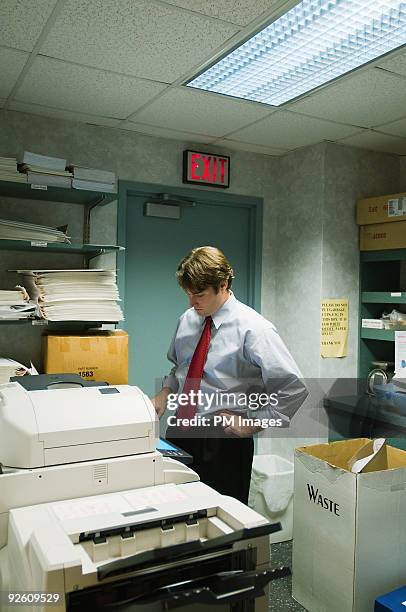 businessman using copy machine - bored worker fotografías e imágenes de stock