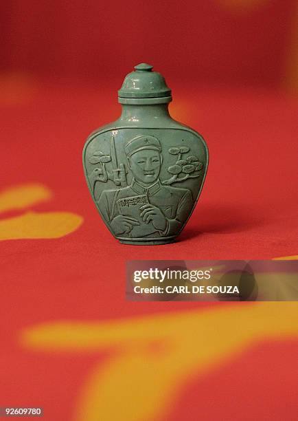 Chinese snuff bottle depicting Lei Feng in carved tourquoise dating 1966-70 is pictured at Bloomsbury auction house, in London on November 2, 2009....