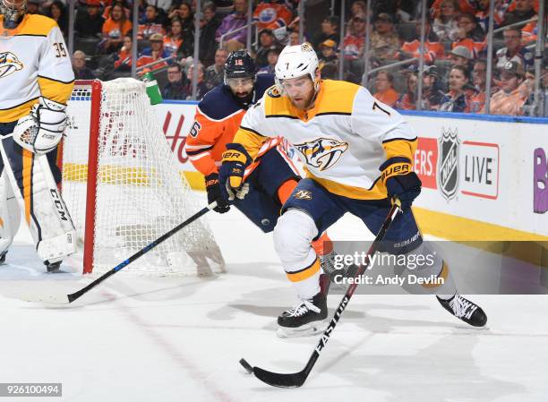 Yannick Weber of the Nashville Predators skates with the puck while being pursued by Jujhar Khaira of the Nashville Predators on March 1, 2017 at...