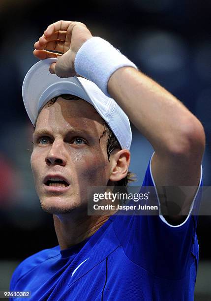 Tomas Berdych of the Czech Republic takes off his cap at the end of his first round match against Paul-Henri Mathieu of France during the ATP 500...