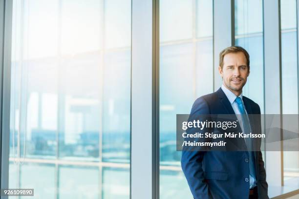 portrait of confident businessman at office - full suit stock pictures, royalty-free photos & images