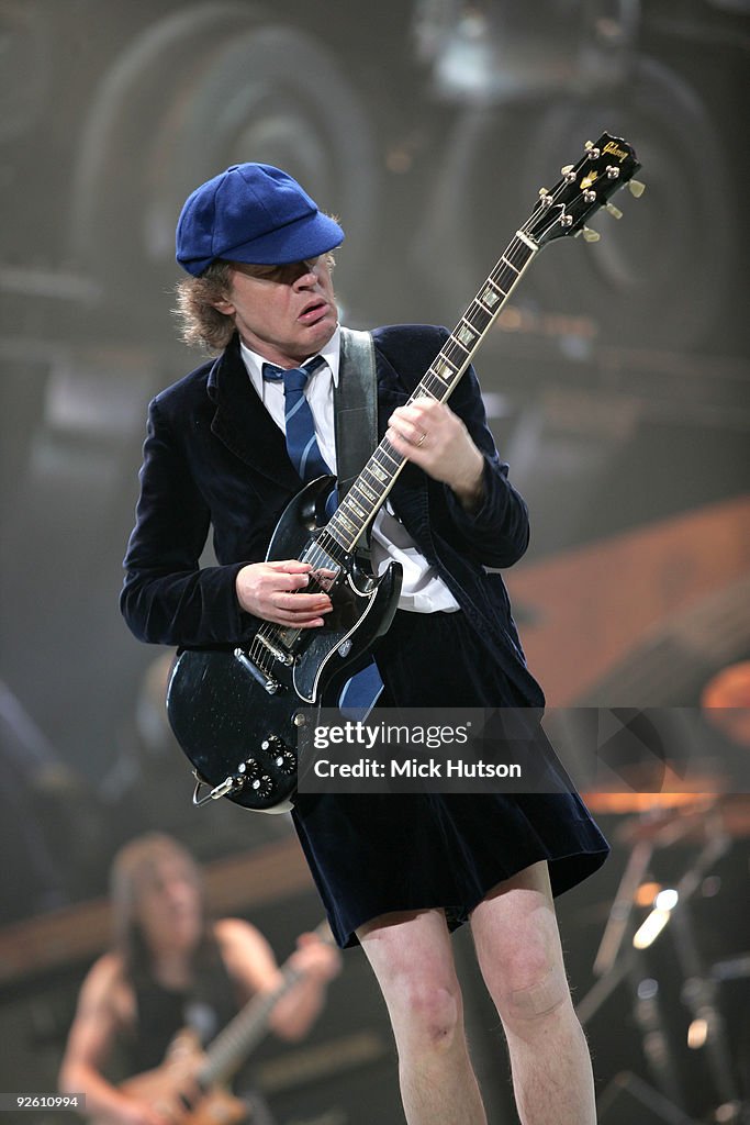 Angus Young of AC/DC performs on stage, playing a Gibson SG guitar ...