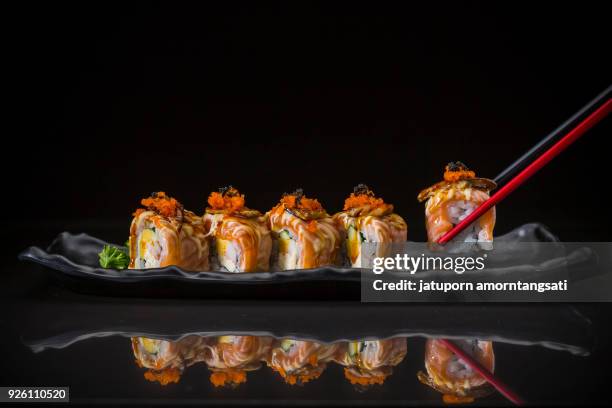 salmon roll topped caviar and foie gras - sushi foto e immagini stock