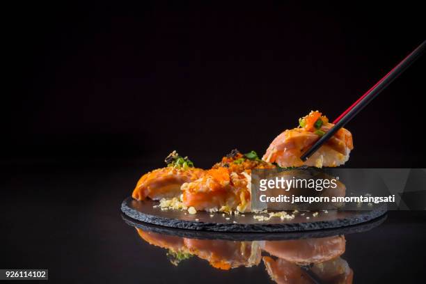 sushi salmon burned and topped with shrimp eggs - japanese food stock pictures, royalty-free photos & images