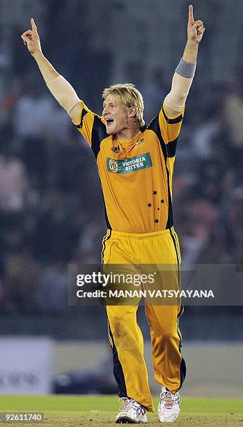 Australian cricketer Shane Watson celebrates after defeating India during the fourth One-Day International match at the Punjab Cricket Association...