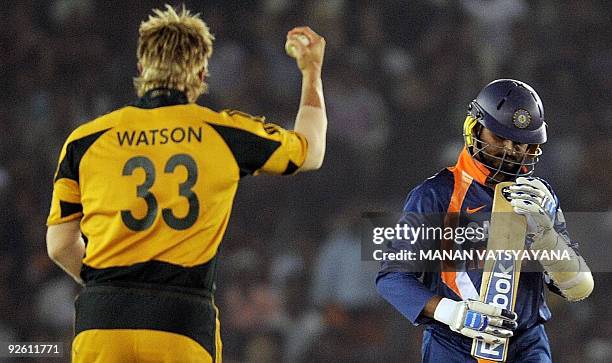 Indian cricketer Harbhajan Singh walks back after his dismissal as Australian Shane Watson reacts during the fourth One-Day International match at...