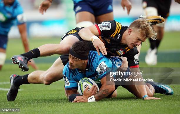 Augustine Pulu of the Blues is tackled by the Chiefs Damian McKenzie during the round two Super Rugby match between the Blues and the Chiefs at Eden...