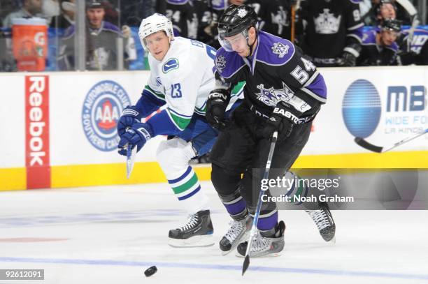 Teddy Purcell of the Los Angeles Kings skates with the puck against Alexander Edler of the Vancouver Canucks on October 29, 2009 at Staples Center in...