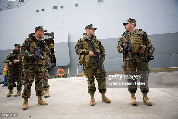 Armed military personnel guard during an arrival ceremony of the amphibious transport dock ship the soon to be commissioned USS New York on November...