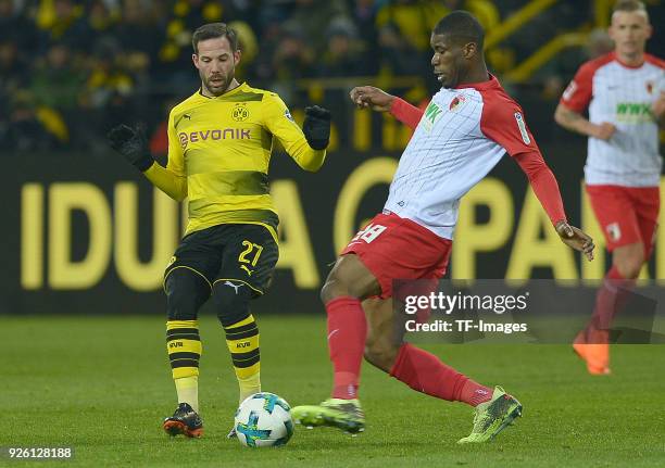 Gonzalo Castro of Dortmund and Kevin Danso of Augsburg battle for the ball during the German Bundesliga match between Borussia Dortmund v FC Augsburg...