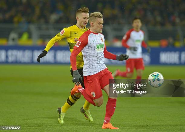 Philipp Max of Augsburg and Marco Reus of Dortmund battle for the ball during the German Bundesliga match between Borussia Dortmund v FC Augsburg at...