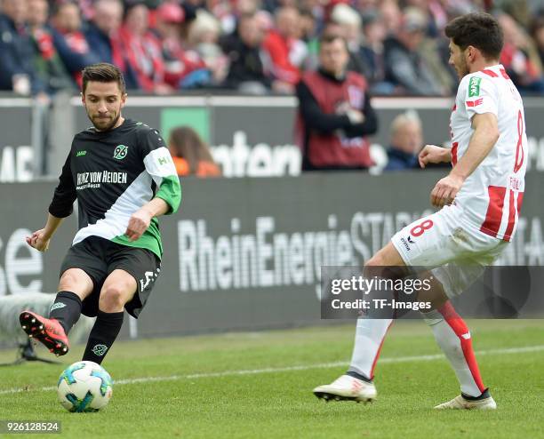 Julian Korb of Hannover and Milos Jojic of Koeln battle for the ball during the Bundesliga match between 1. FC Koeln and Hannover 96 at...