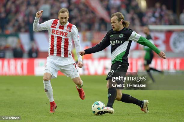 Marcel Risse of Koeln and Iver Fossum of Hannover battle for the ball during the Bundesliga match between 1. FC Koeln and Hannover 96 at...