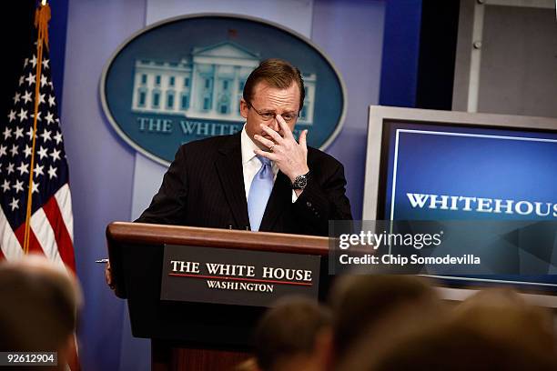 White House Press Secretary Robert Gibbs pushes up his glasses during the daily press briefing at the White House November 2, 2009 in Washington, DC....