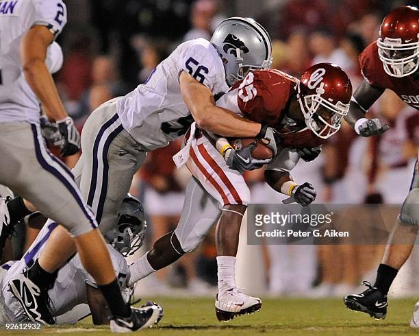 Linebacker Alex Hrebec of the Kansas State Wildcats tackles wide receiver Ryan Broyles of the Oklahoma Sooners from behind in the second half on...