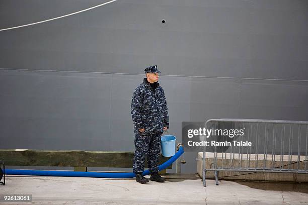 Military serviceman works as the amphibious transport dock ship on the soon to be comissioned USS New York docks at pier 88 during an arrival...