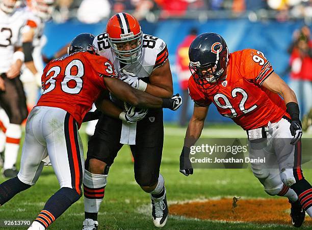 Danieal Manning and Hunter Hillenmeyer of the Chicago Bears tackle Steve Heiden of the Cleveland Browns at Soldier Field on November 1, 2009 in...