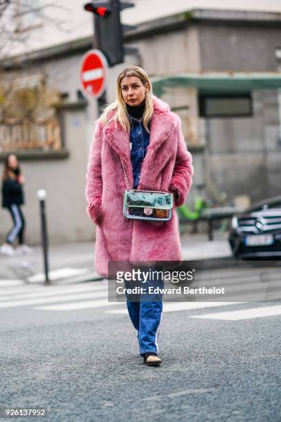 Irina Lakicevic wears a shiny Chanel bag and a pink fur coat, during Paris Fashion Week Womenswear Fall/Winter 2018/2019, on March 1, 2018 in Paris,...