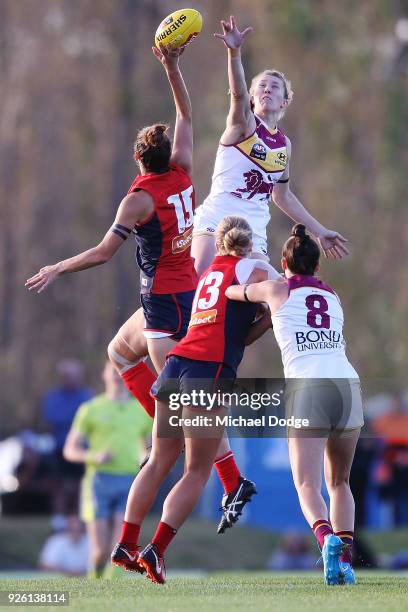 Lauren Pearce of the Demons and Brittany Gibson of the Lions compete for the ball during the round five AFLW match between the Melbourne Demons and...