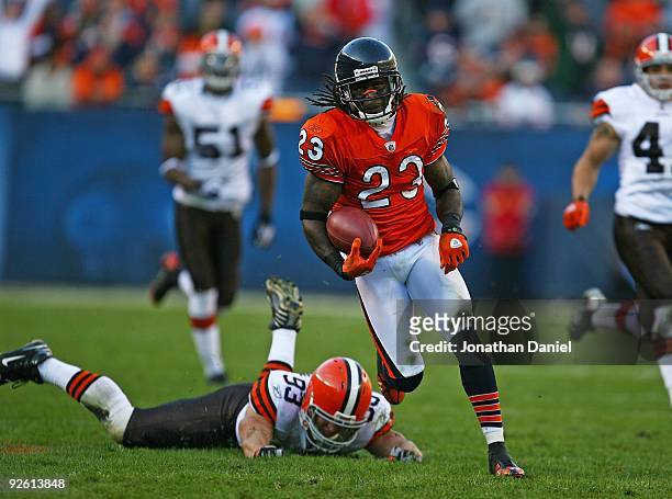 Devin Hester of the Chicago Bears returns a punt as Jason Trusnik of the Cleveland Browns misses a tackle at Soldier Field on November 1, 2009 in...