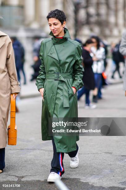 Yasmin Sewell wears a green trench coat, during Paris Fashion Week Womenswear Fall/Winter 2018/2019, on March 1, 2018 in Paris, France.