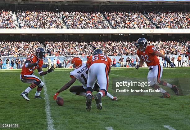 Mohamed Massaquoi of the Cleveland Browns fumbles as Charles Tillman, Nick Roach and Hunter Hillenmeyer of the Chicago Bears move to the ball at...
