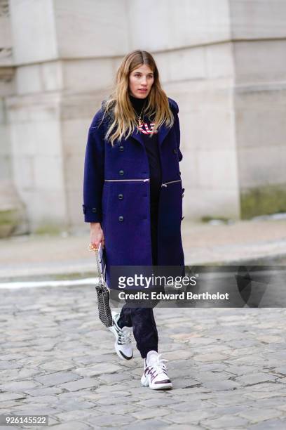 Veronika Heilbrunner wears a blue coat, a turtleneck, a bag, sneakers , during Paris Fashion Week Womenswear Fall/Winter 2018/2019, on March 1, 2018...