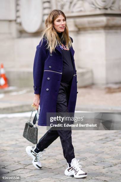 Veronika Heilbrunner wears a blue coat, a turtleneck, a bag, sneakers , during Paris Fashion Week Womenswear Fall/Winter 2018/2019, on March 1, 2018...