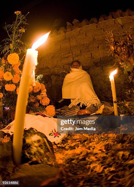 Locals attend celebrations of the Dia de los Muertos at the Arocutin Cemetery on November 1, 2009 in Morelia, Mexico.