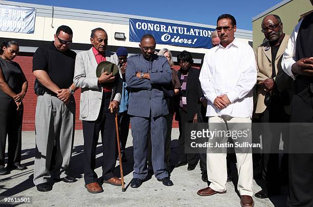 Faith leaders bow their heads during a prayer vigil for a fifteen year-old rape victim in front of Richmond High School November 2, 2009 in Richmond,...