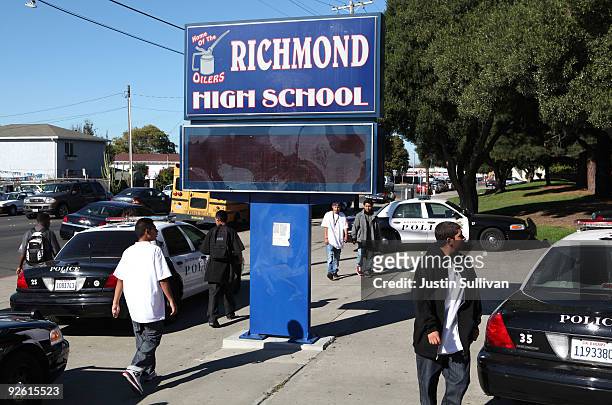 Students walk by Richmond, California police cars that are parked in front of Richmond High School November 2, 2009 in Richmond, California. Faith...