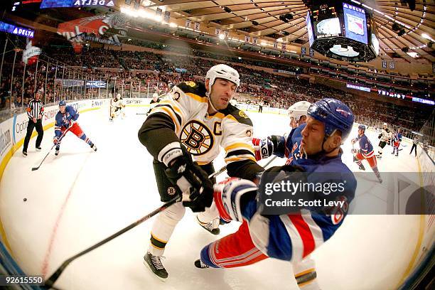 Sean Avery of the New York Rangers is checked against the boards by Zdeno Chara of the Boston Bruins on November 1, 2009 at Madison Square Garden in...