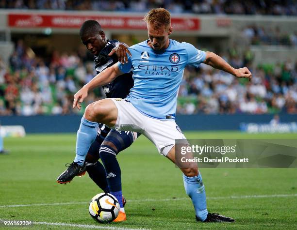 Oliver Bozanic of Melbourne City contests the ball with Leroy George of the Victory during the round 22 A-League match between Melbourne City FC and...