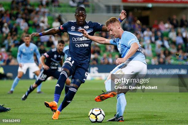 Oliver Bozanic of Melbourne City contests the ball with Leroy George of the Victory during the round 22 A-League match between Melbourne City FC and...