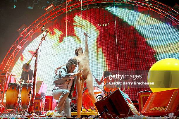 Wayne Coyne of The Flaming Lips is joined on stage by a nude fan at the 2009 Voodoo Experience at City Park on November 1, 2009 in New Orleans,...
