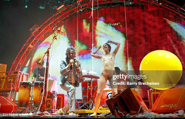 Wayne Coyne of The Flaming Lips is joined on stage by a nude fan at the 2009 Voodoo Experience at City Park on November 1, 2009 in New Orleans,...