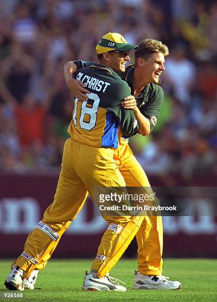 Nathan Braken of Australia celebrates taking the wicket of Sherwin Campbell of the West Indies with Adam Gilchrist, in the Carlton One Day...