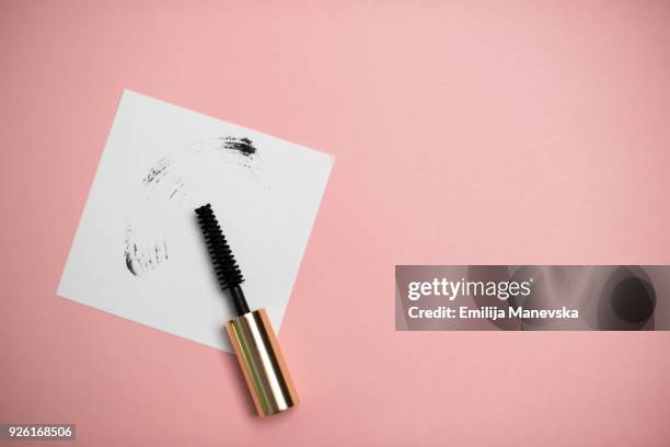 a smear of black mascara brush - mascara stockfoto's en -beelden