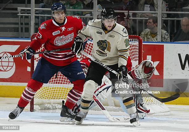Alex Dzielski of the Oshawa Generals holds Colin Martin of the London Knights in check in a game on October 30, 2009 at the John Labatt Centre in...