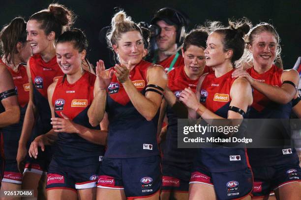 Demons players including Melissa Hickey and Daisy Pearce celebrate after winning during the round five AFLW match between the Melbourne Demons and...