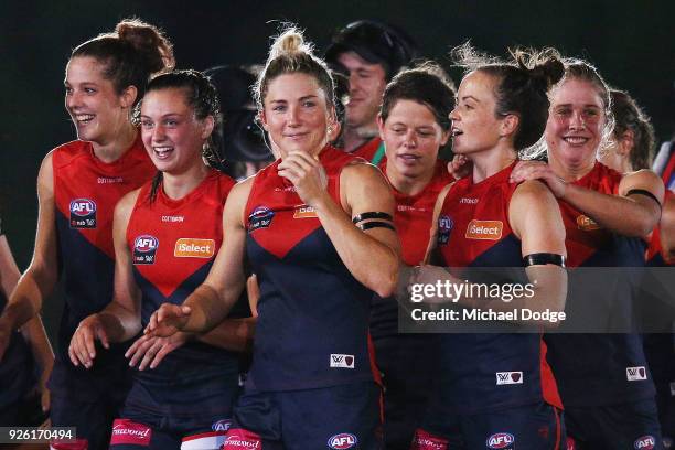 Demons players including Melissa Hickey and Daisy Pearce celebrate after winning during the round five AFLW match between the Melbourne Demons and...