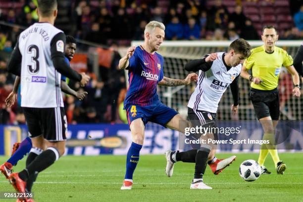 Ivan Rakitic of FC Barcelona fights for the ball with Luciano Vietto of Valencia CF during the Copa Del Rey 2017-18 match between FC Barcelona and...