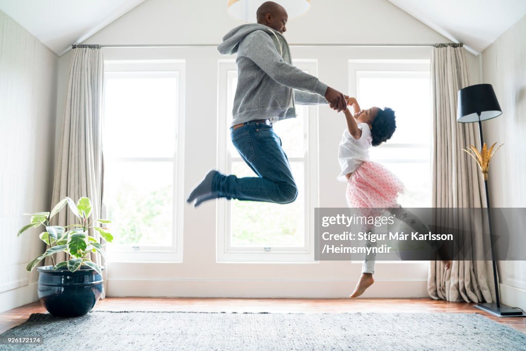 Padre e figlia saltano mentre fanno balletto