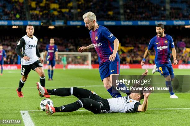 Gabriel Armando de Abreu of Valencia CF trips up with Ivan Rakitic of FC Barcelona during the Copa Del Rey 2017-18 match between FC Barcelona and...
