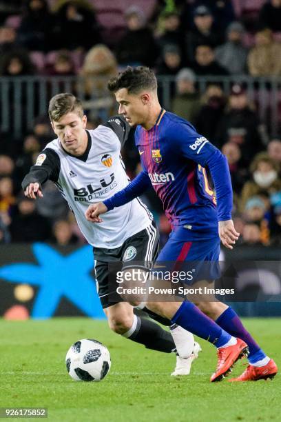 Philippe Coutinho of FC Barcelona fights for the ball with Luciano Vietto of Valencia CF during the Copa Del Rey 2017-18 match between FC Barcelona...