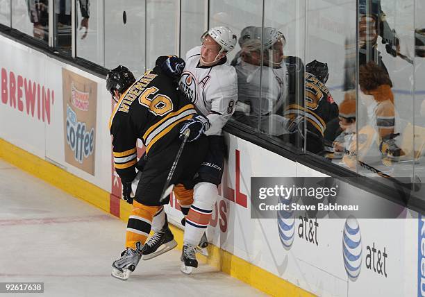 Dennis Wideman of the Boston Bruins checks against Ales Hemsky of the Edmonton Oilers at the TD Garden on October 31, 2009 in Boston, Massachusetts.