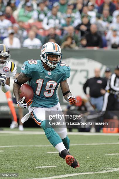 Ted Ginn Jr. #19 of the Miami Dolphins returns a kick off during a game against the New York Jets at Giants Stadium on November 1, 2009 in East...