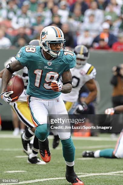 Ted Ginn Jr. #19 of the Miami Dolphins returns a kick off during a game against the New York Jets at Giants Stadium on November 1, 2009 in East...