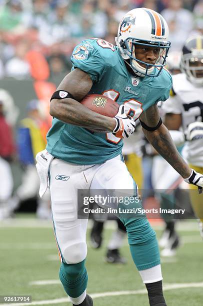 Ted Ginn Jr. #19 of the Miami Dolphins returns a kick off during a game against the New York Jets at Giants Stadium on November 1, 2009 in East...