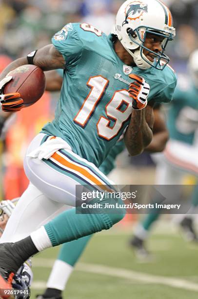 Ted Ginn Jr. #19 of the Miami Dolphins returns a kick off during a game against the New York Jets at Giants Stadium on November 1, 2009 in East...